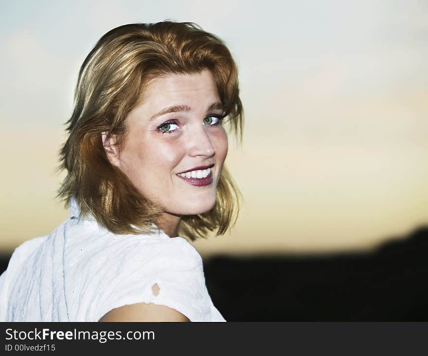 Close up of blonde woman as she turns towards the camera.