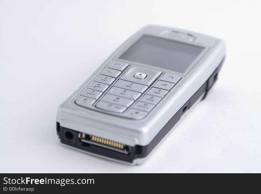 A modern grey  mobile  telephone. A modern grey  mobile  telephone