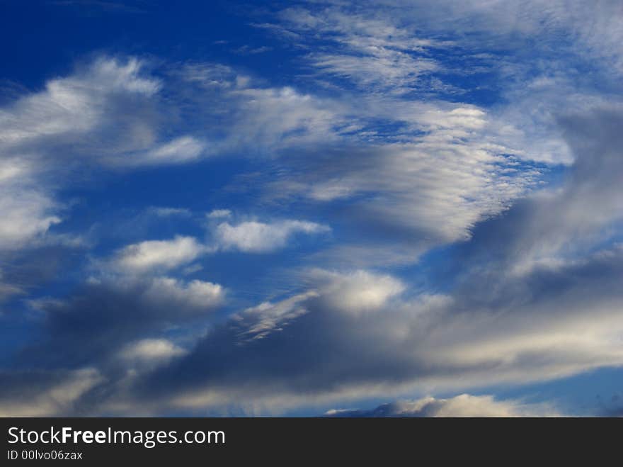 A dark blue sky with clouds on a autumn day. A dark blue sky with clouds on a autumn day.