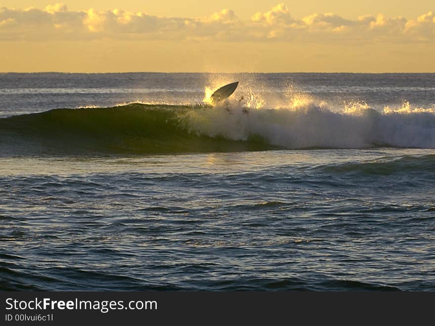 Sunrise surfer wipeout