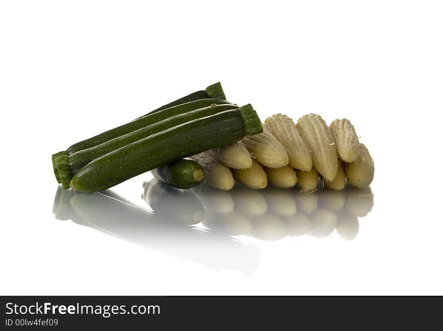 Baby zucchini and corn isolated over white background