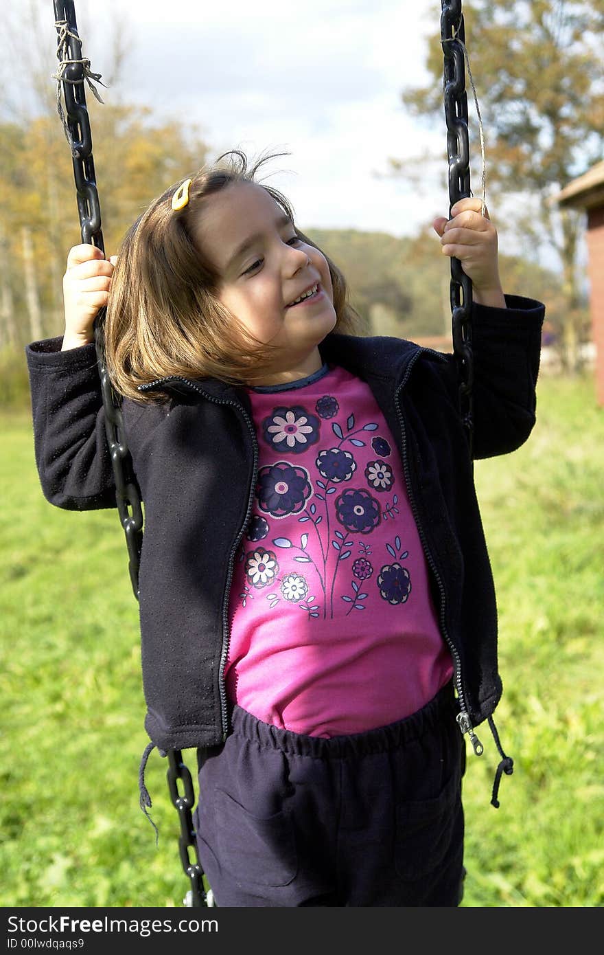 Little girl being playing on grass field. Little girl being playing on grass field