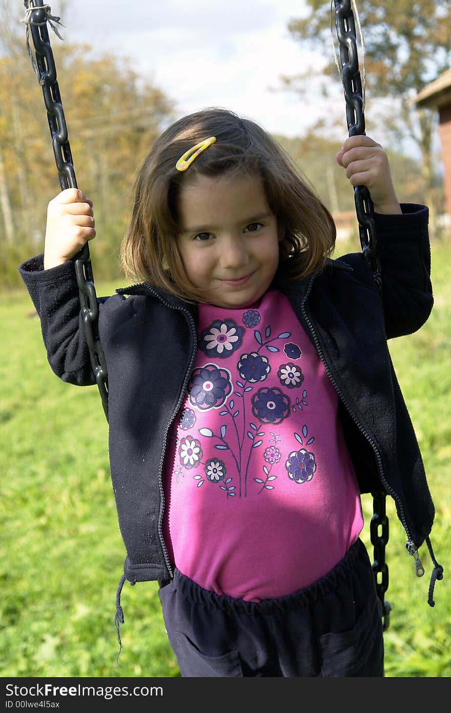 Little girl playing on grass field. Little girl playing on grass field