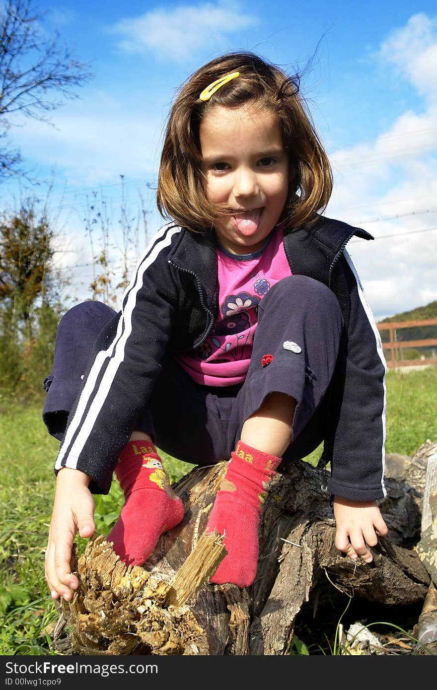 Little girl being silly on grass field. Little girl being silly on grass field