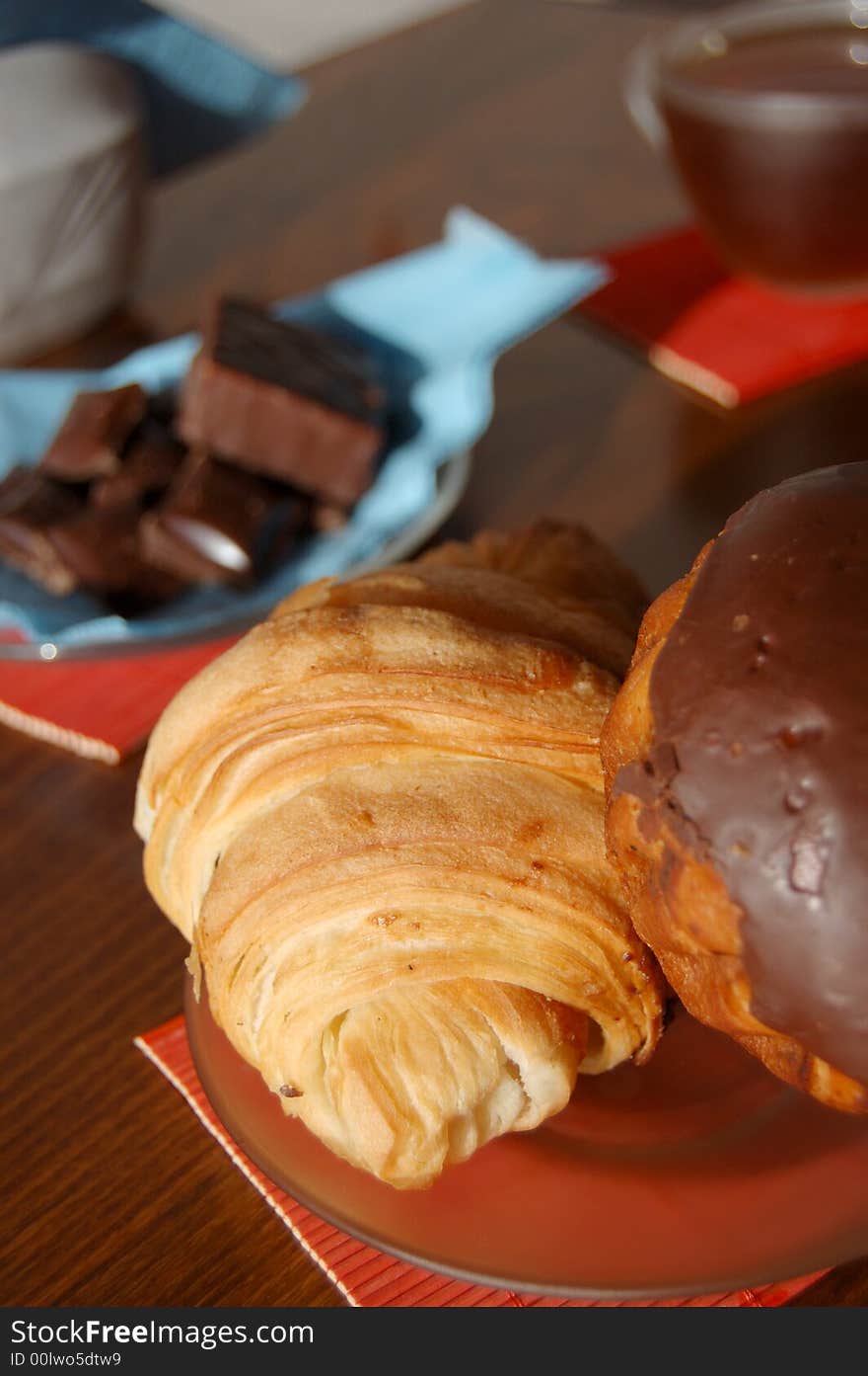 Breakfast with croissant, sweets and a cup of tea. Breakfast with croissant, sweets and a cup of tea