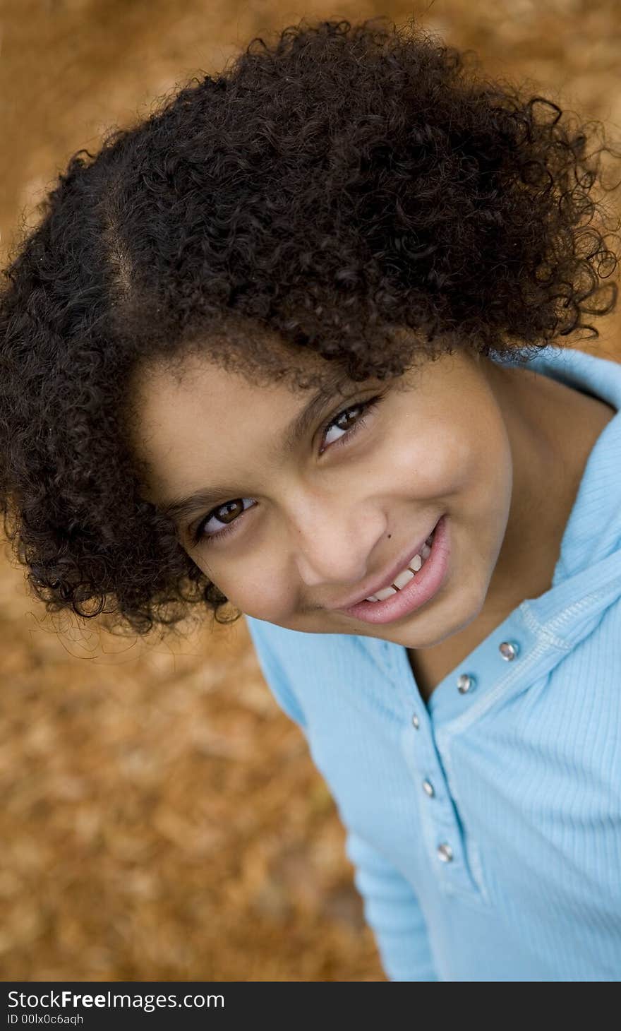 Image of a pretty biracial girl looking up at viewer