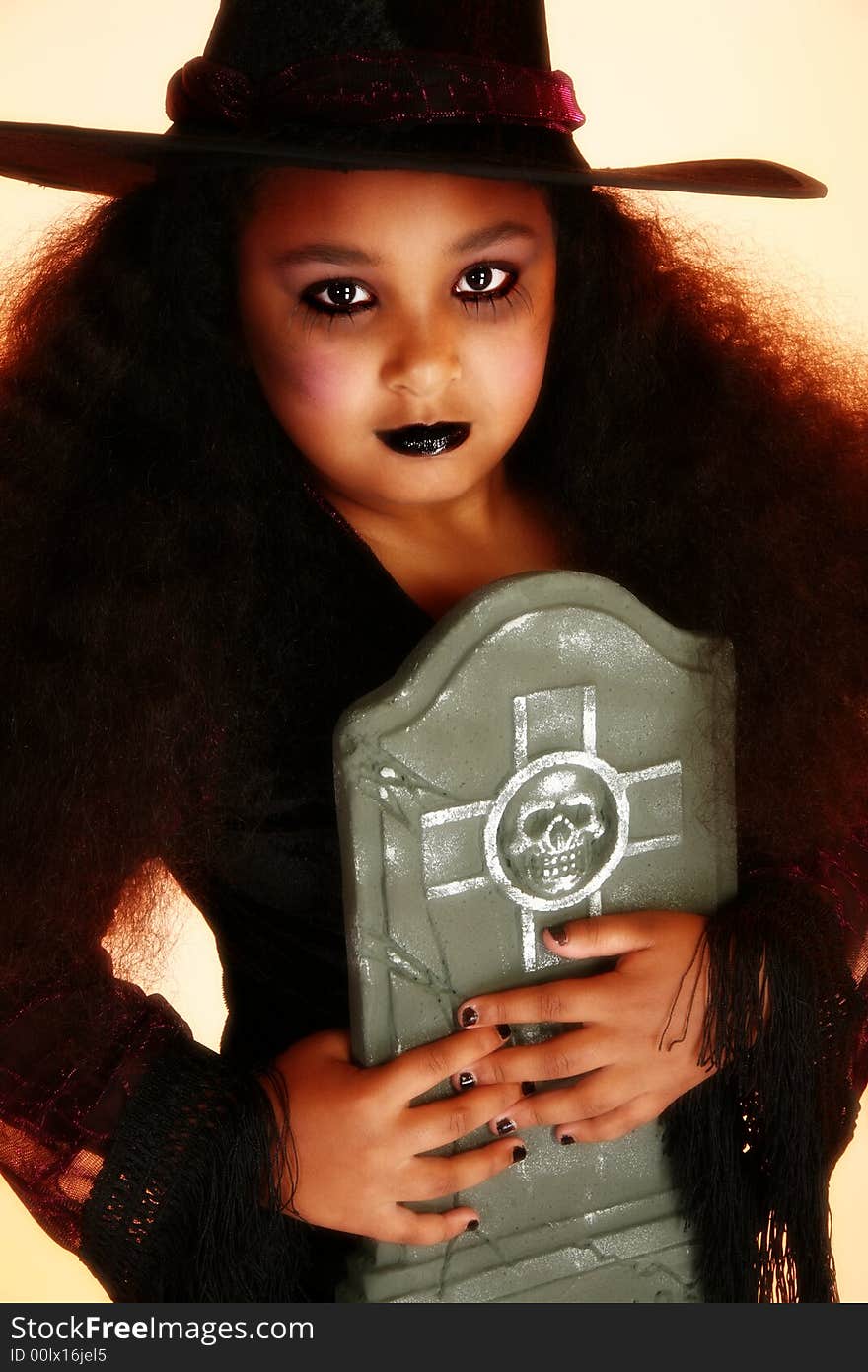 Beautiful 10 year old African American girl dressed as a witch for halloween. Beautiful 10 year old African American girl dressed as a witch for halloween.