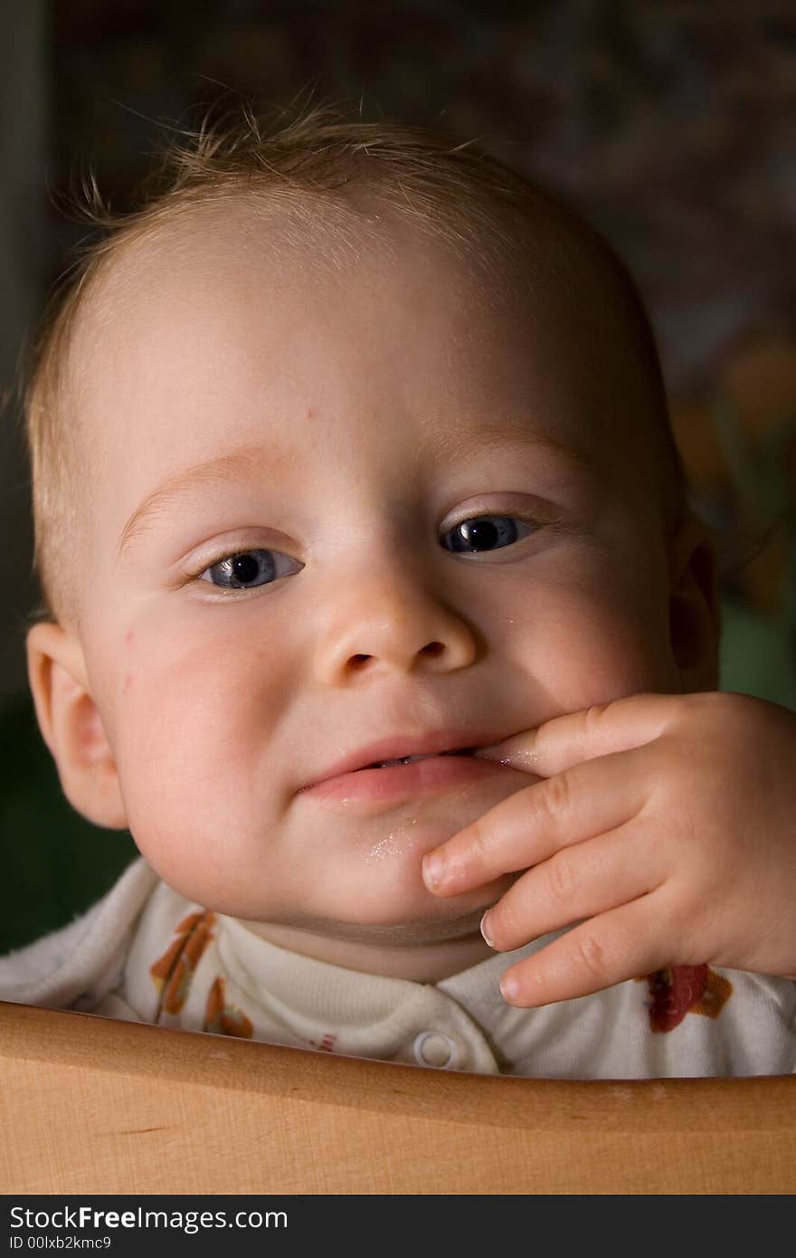 Baby in the bed sucking finger