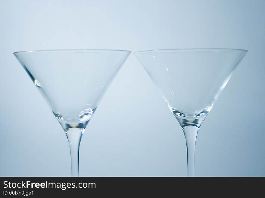 Martini glasses, or champagne glasses, or stem cocktail glasses over white background