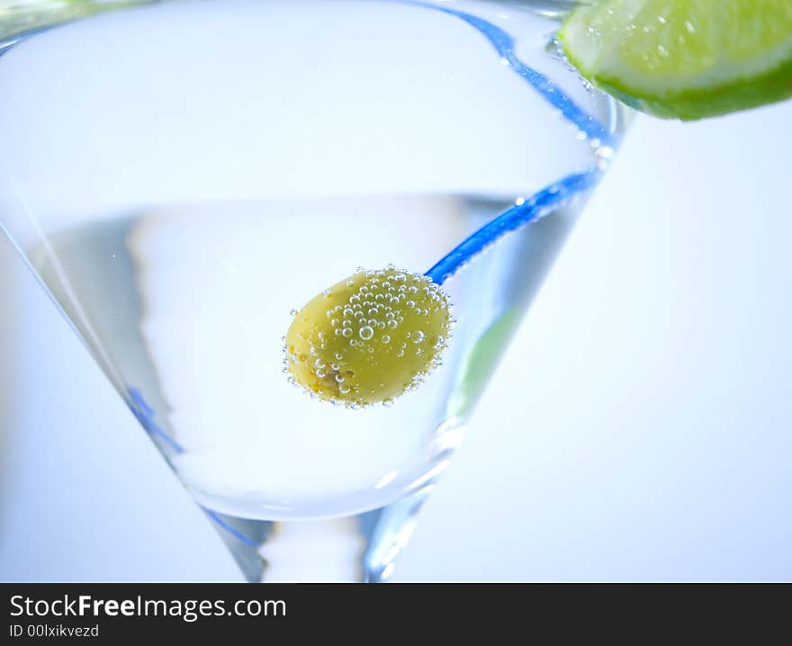 Green olive in martini