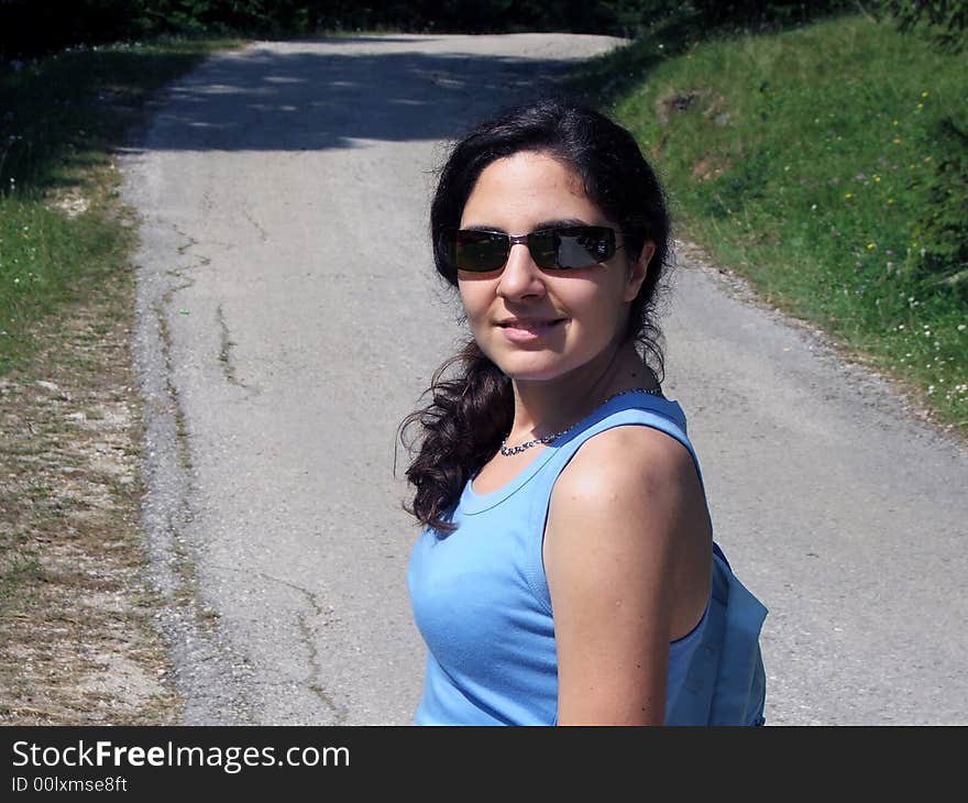 Girl walking up the mountain wearing sunglasses