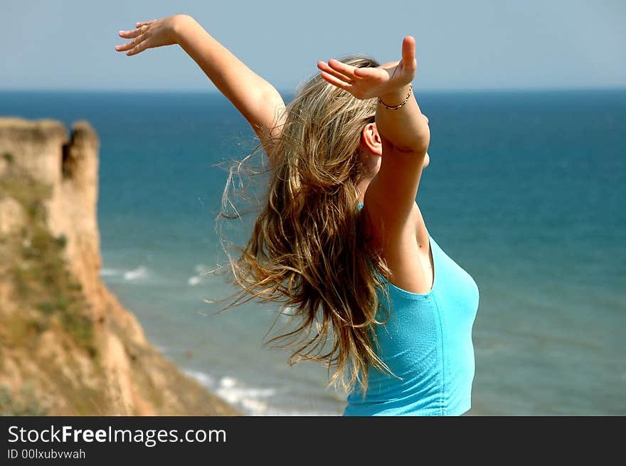 Girl Fortunately, summer, the sea, their hands in flight. Girl Fortunately, summer, the sea, their hands in flight