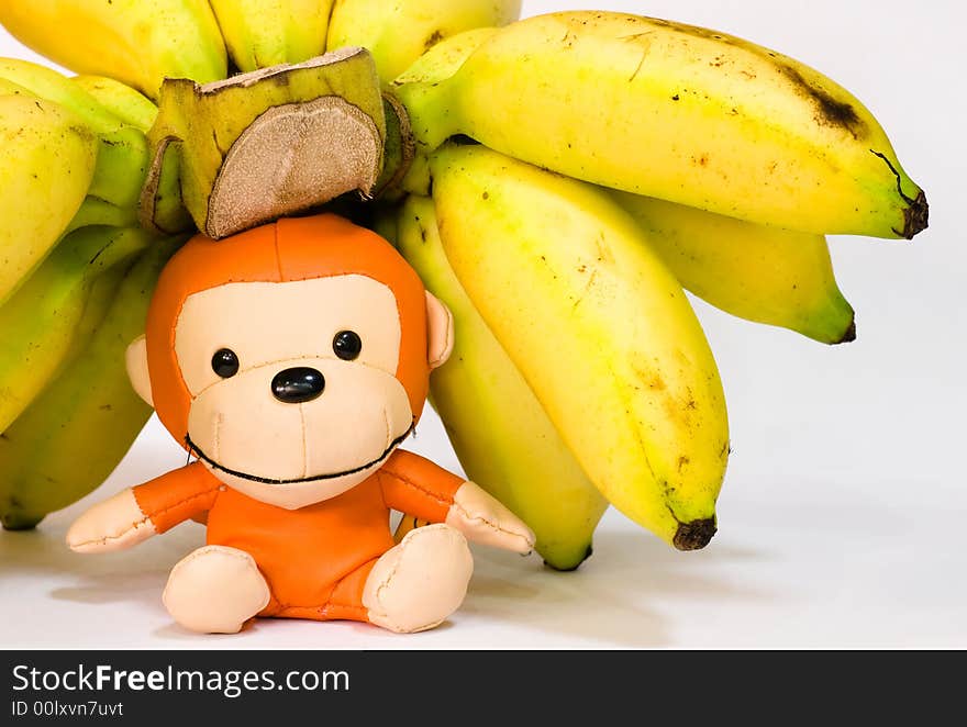 Still Life: Bananas on table top with toy monkey. Still Life: Bananas on table top with toy monkey