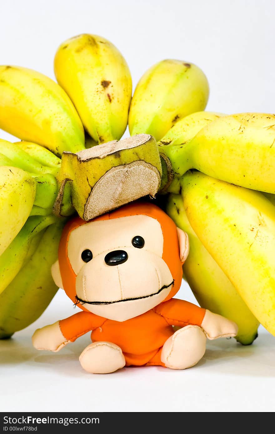 Still Life: Bananas on table top with toy monkey. Still Life: Bananas on table top with toy monkey