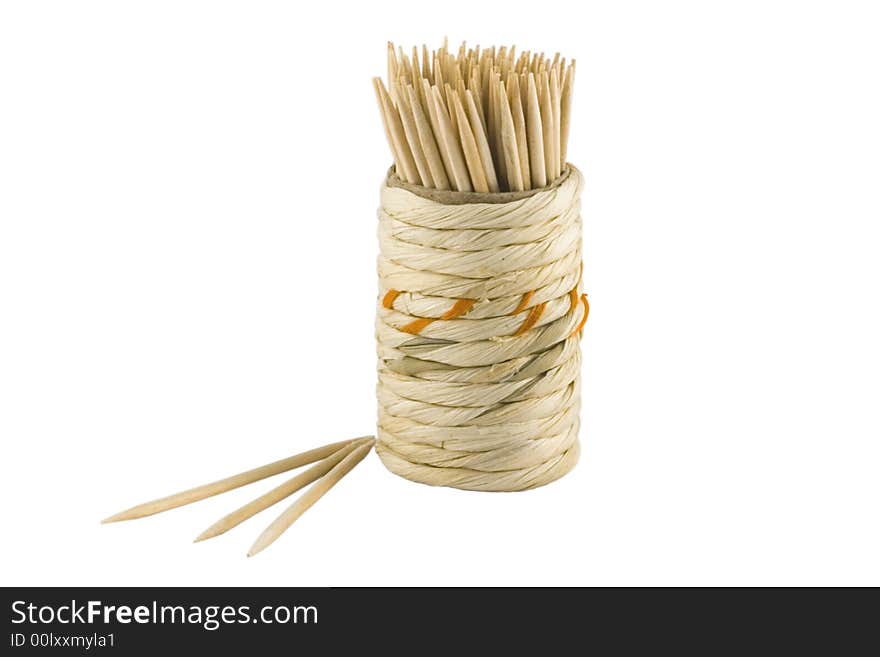 Wooden tooth-picks in the braiding box on the white background. Wooden tooth-picks in the braiding box on the white background