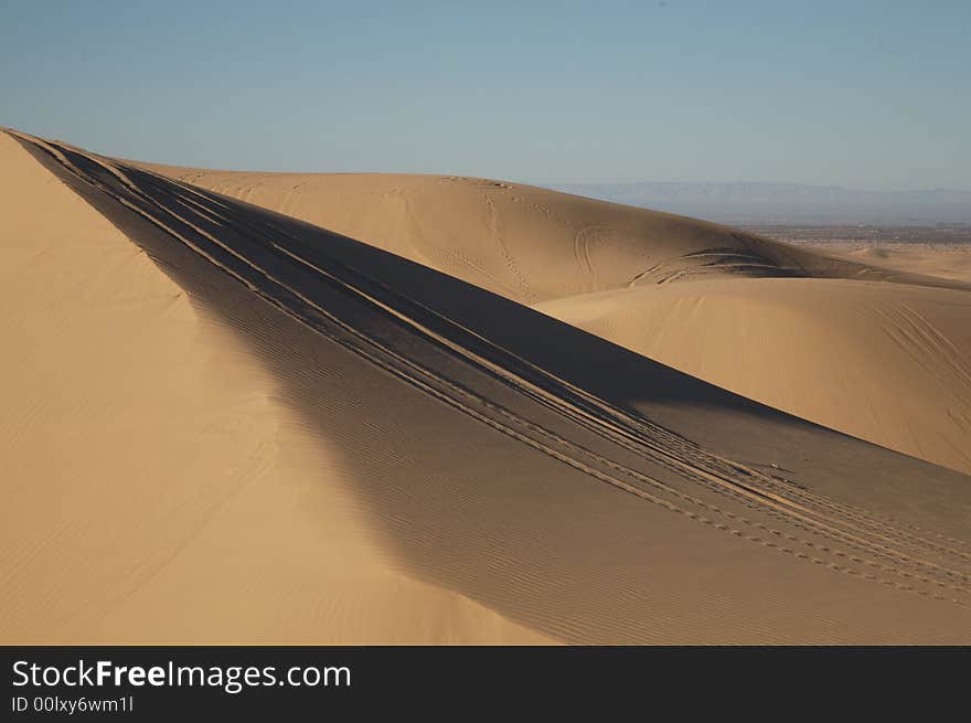 Beautiful sand dunes in Glamis California, with vehicle tracks.