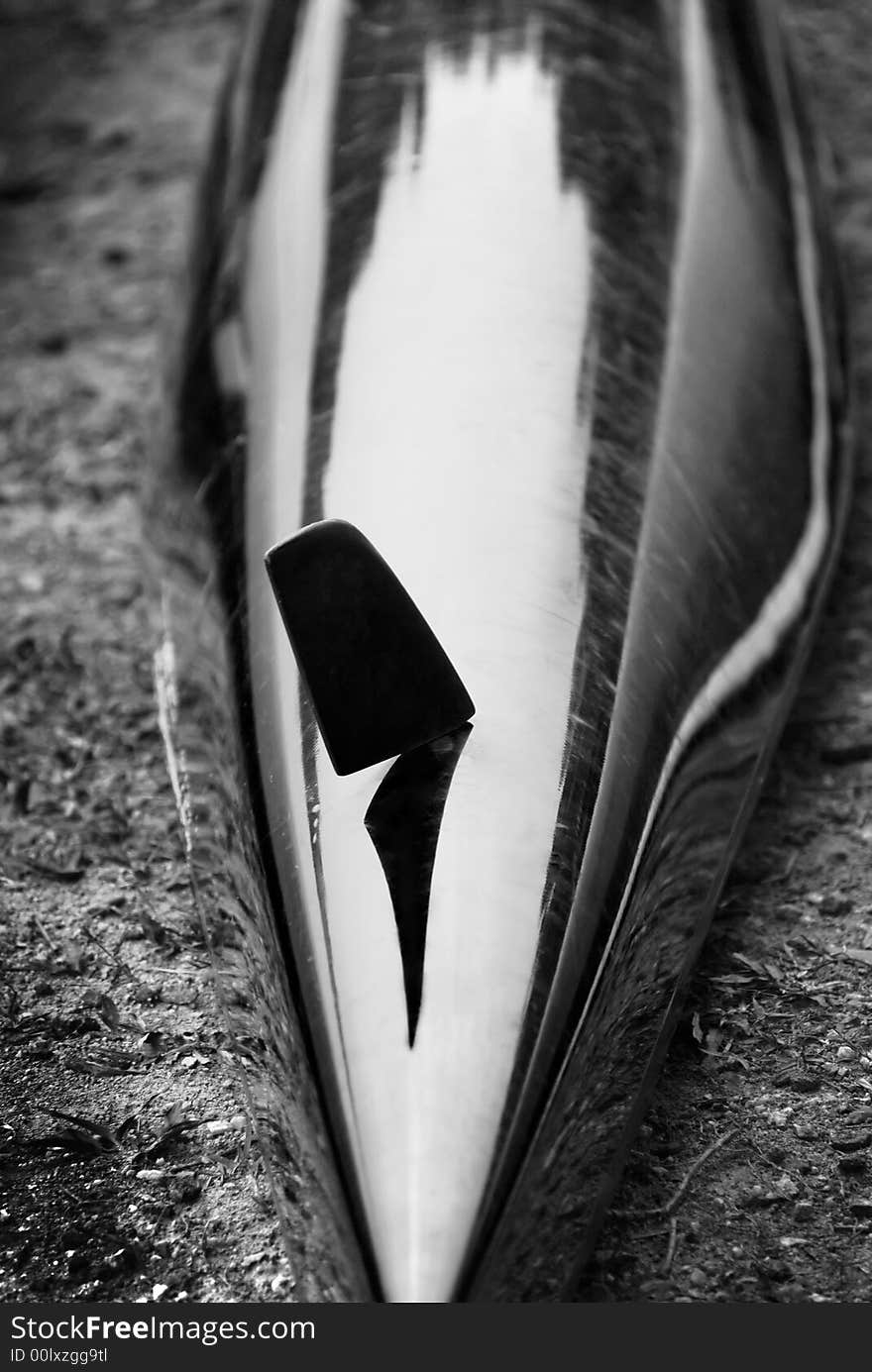 The rudder's shadow and reflection of trees around on the kayak (black & white). The rudder's shadow and reflection of trees around on the kayak (black & white)