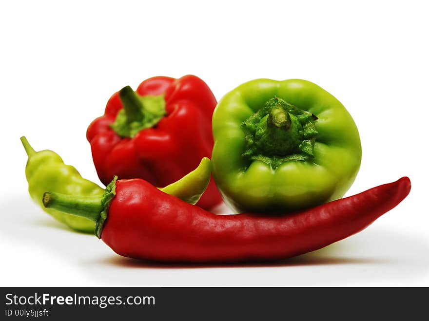 Red and green peppers isolated on white