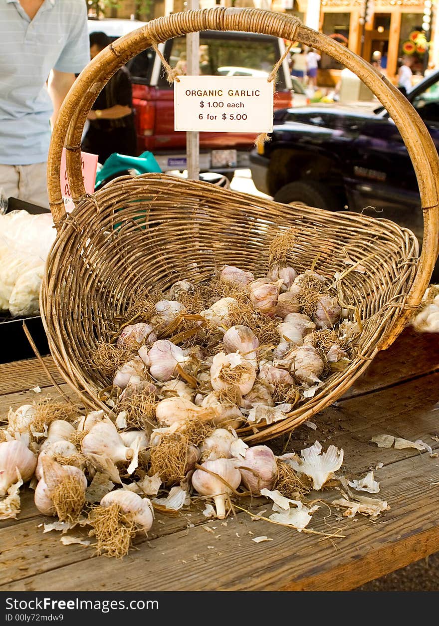 Basket of fresh, organic garlic at a local farmer's market. Basket of fresh, organic garlic at a local farmer's market