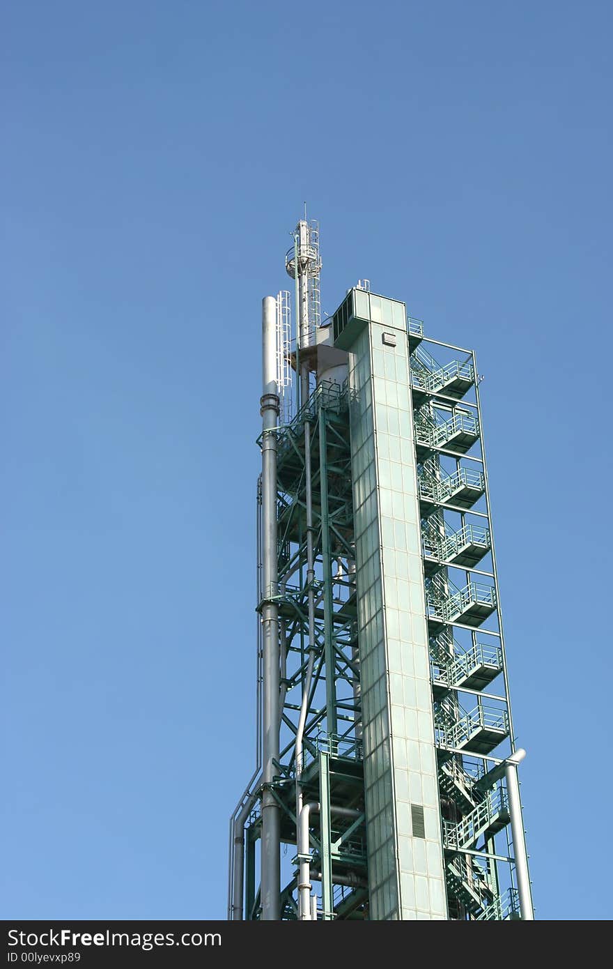 Chimney on a industrial building with blue sky as background