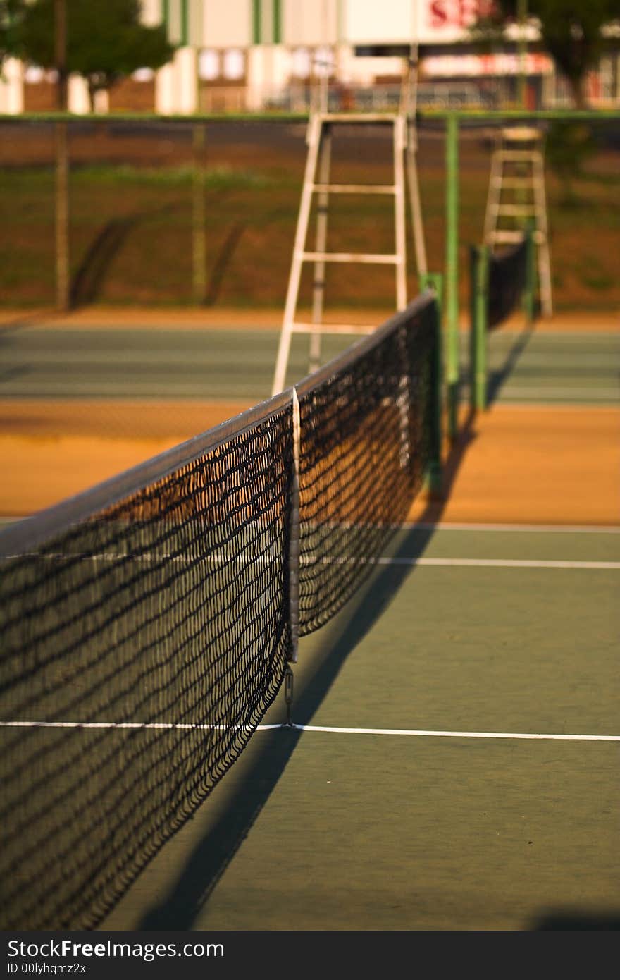 Tennis court net view with net in focus and the umpire's seat blurred