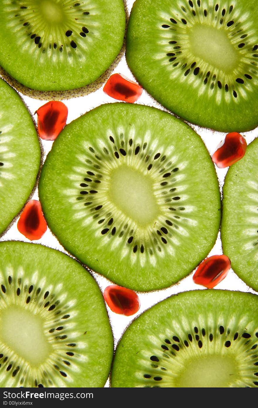 Kiwi and pomegranate on a white background