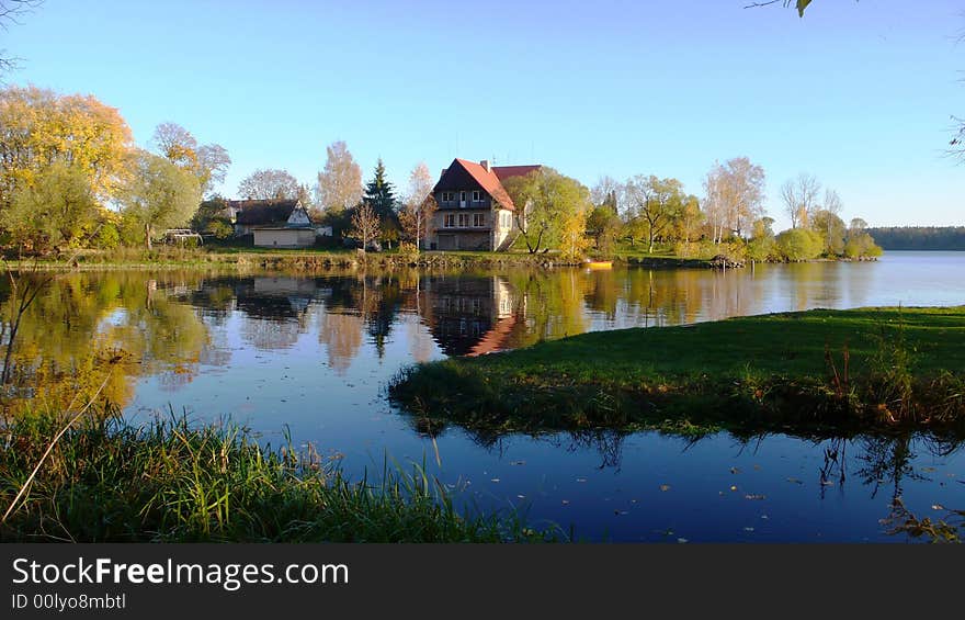 Rural house on the lonely island in lake in autumn time. Rural house on the lonely island in lake in autumn time