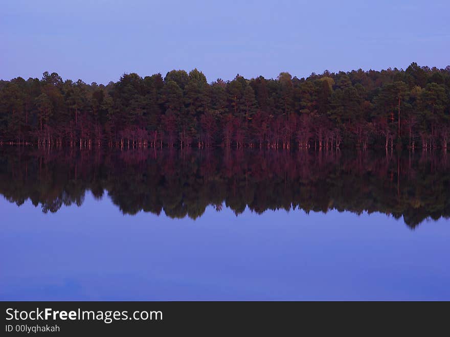 A warm purple glow in a lake reflection.In Rockingham North Carolina USA. A warm purple glow in a lake reflection.In Rockingham North Carolina USA