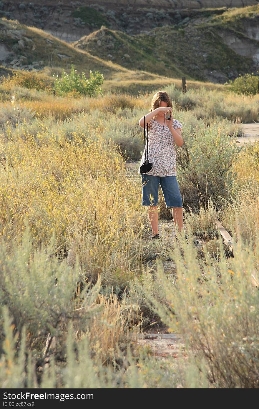 Portrait of a young girl taking pictures outdoors. Portrait of a young girl taking pictures outdoors.