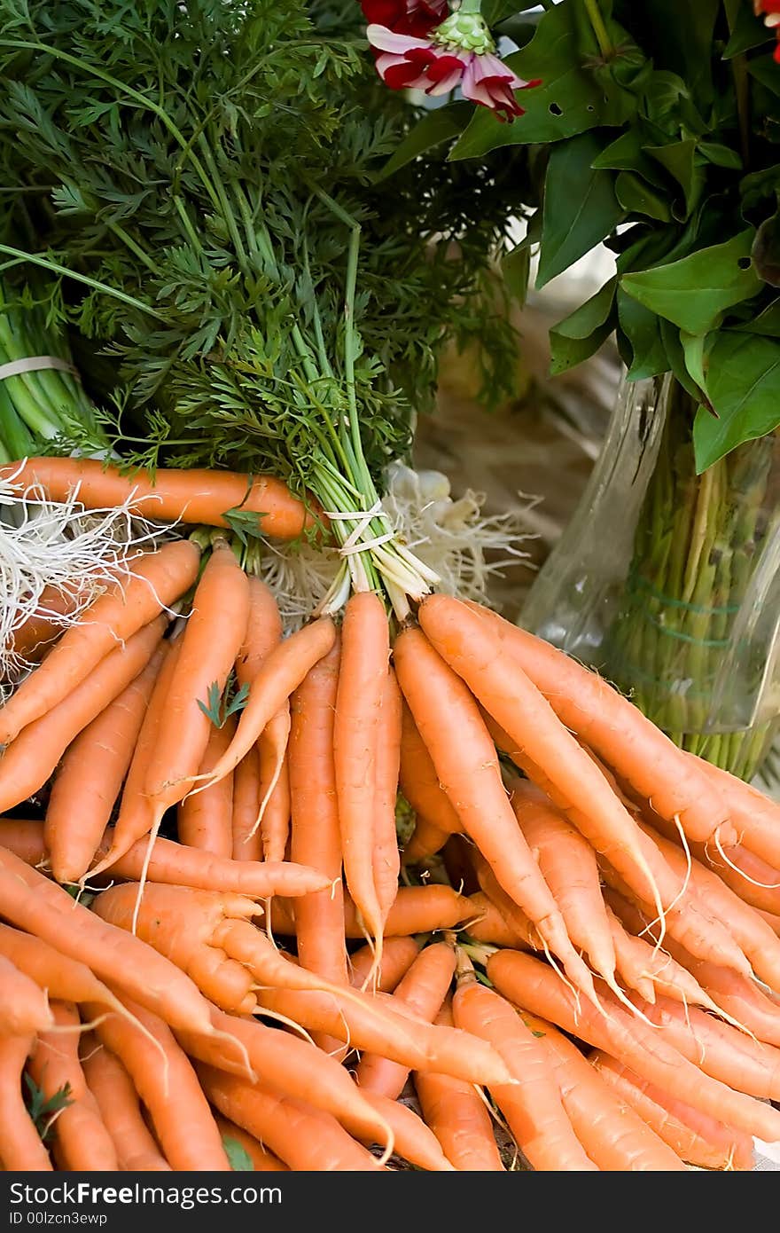 Bundles of organic, fresh carrots for sale at local farmer's market