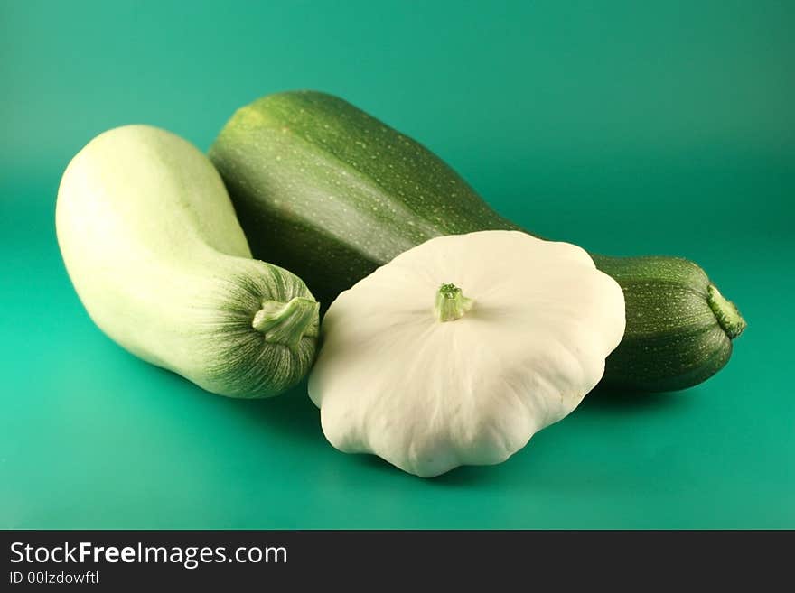 Two  marrows and bush pumpkin on a green background.