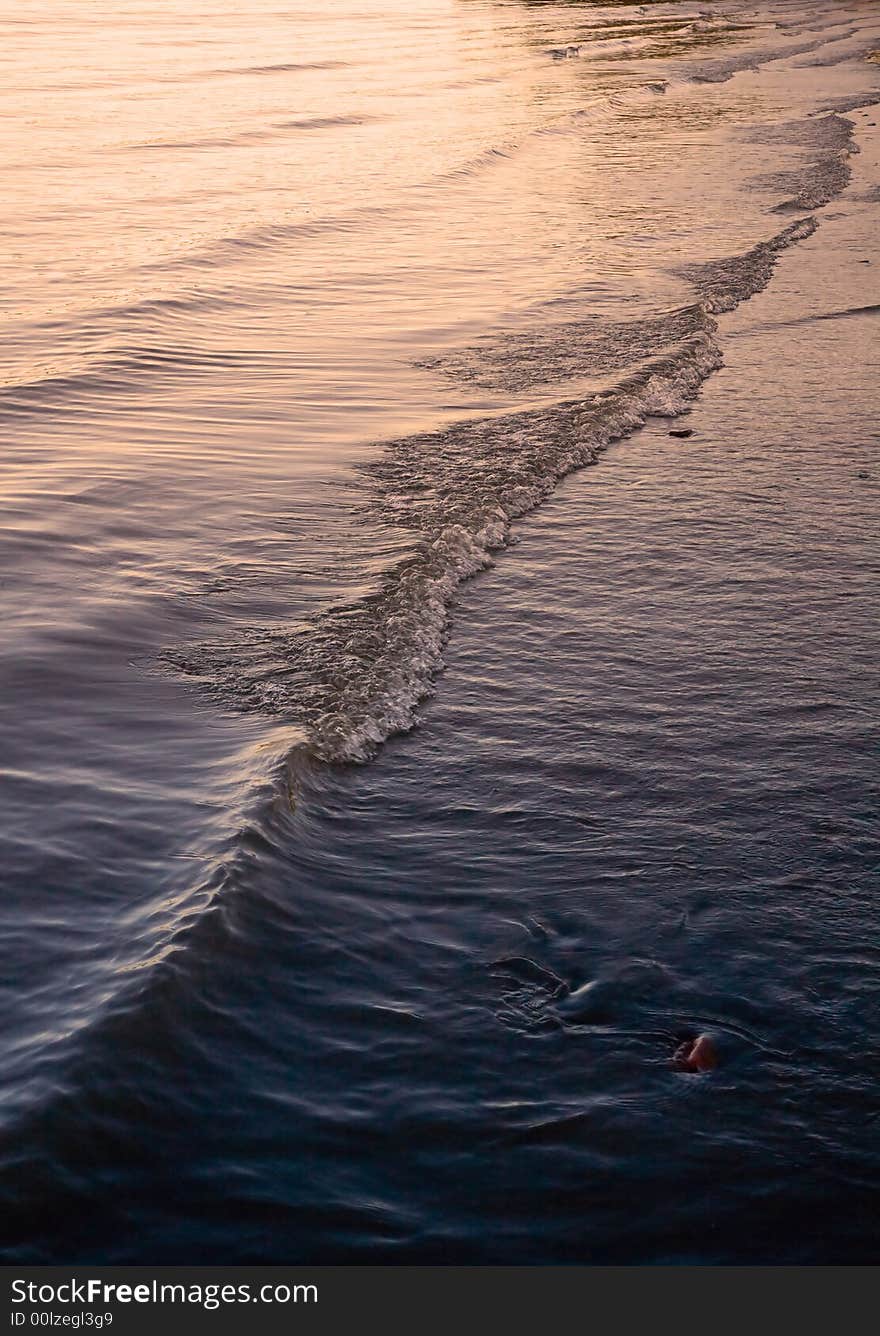 Rolling wave on a beach shore line. Rolling wave on a beach shore line