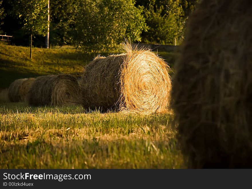 Four straw bales, second is lit uniquely