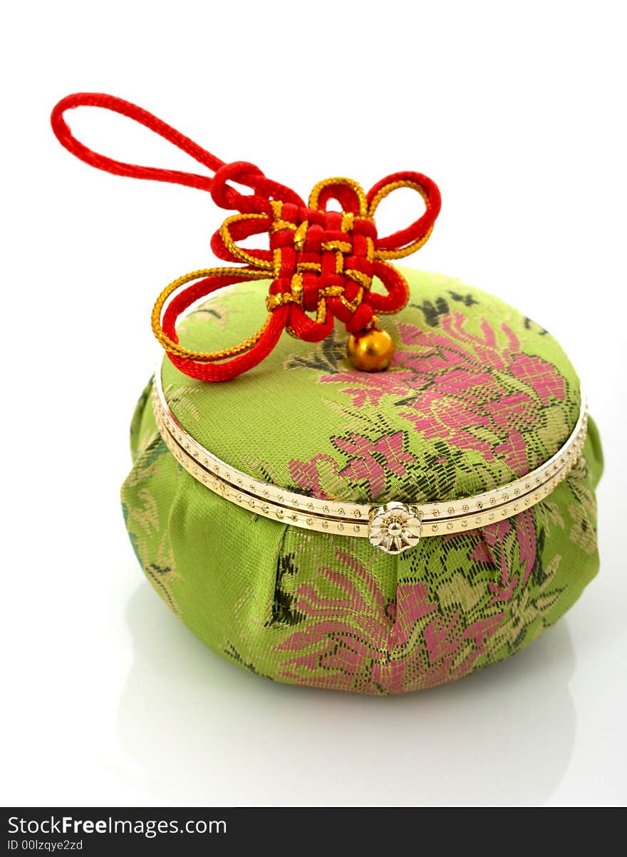 A green chinese jewelry container over a white background