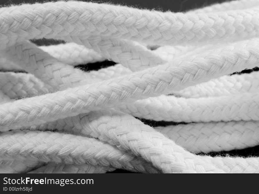 Macro detail pf someome plaited white wollropes. Macro detail pf someome plaited white wollropes.