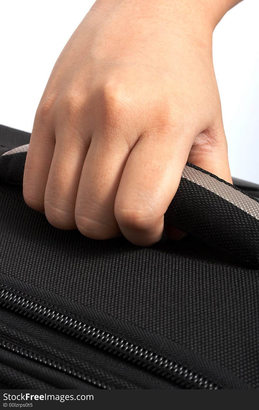 A hand carrying a bag over a white background. A hand carrying a bag over a white background