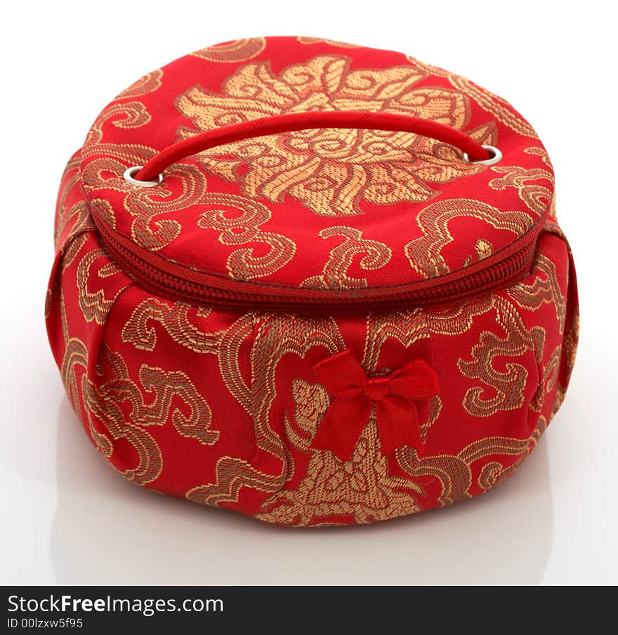 A red chinese jewelry container over a white background