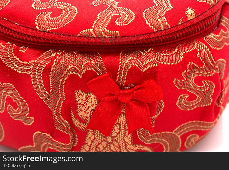 A red chinese jewelry container over a white background