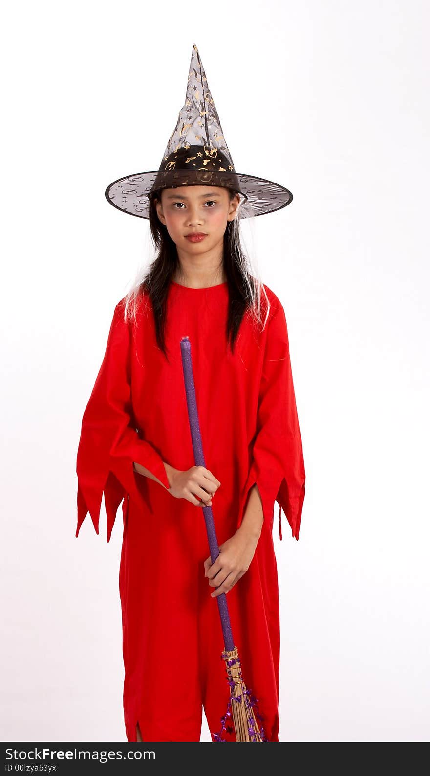 A young girl dressed in a witch costume