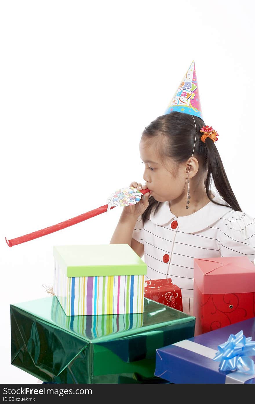 A girl wearing a party hat over a white background. A girl wearing a party hat over a white background