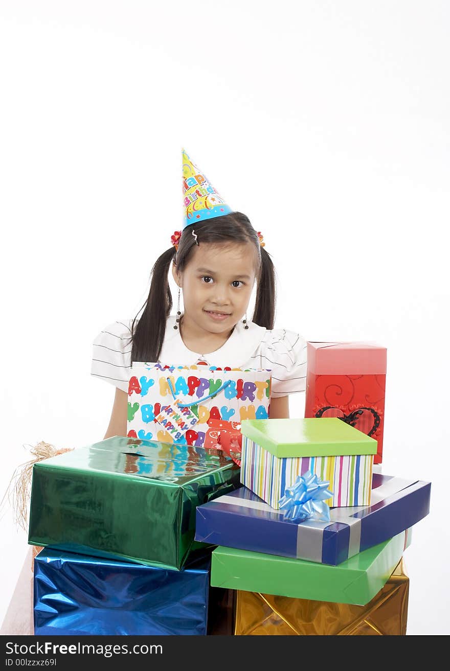 A girl wearing a party hat over a white background. A girl wearing a party hat over a white background