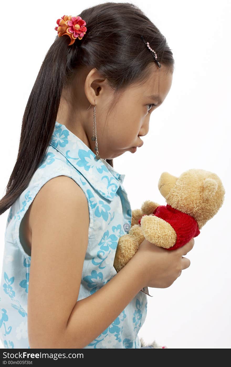 A girl with a teddy bear over a white background