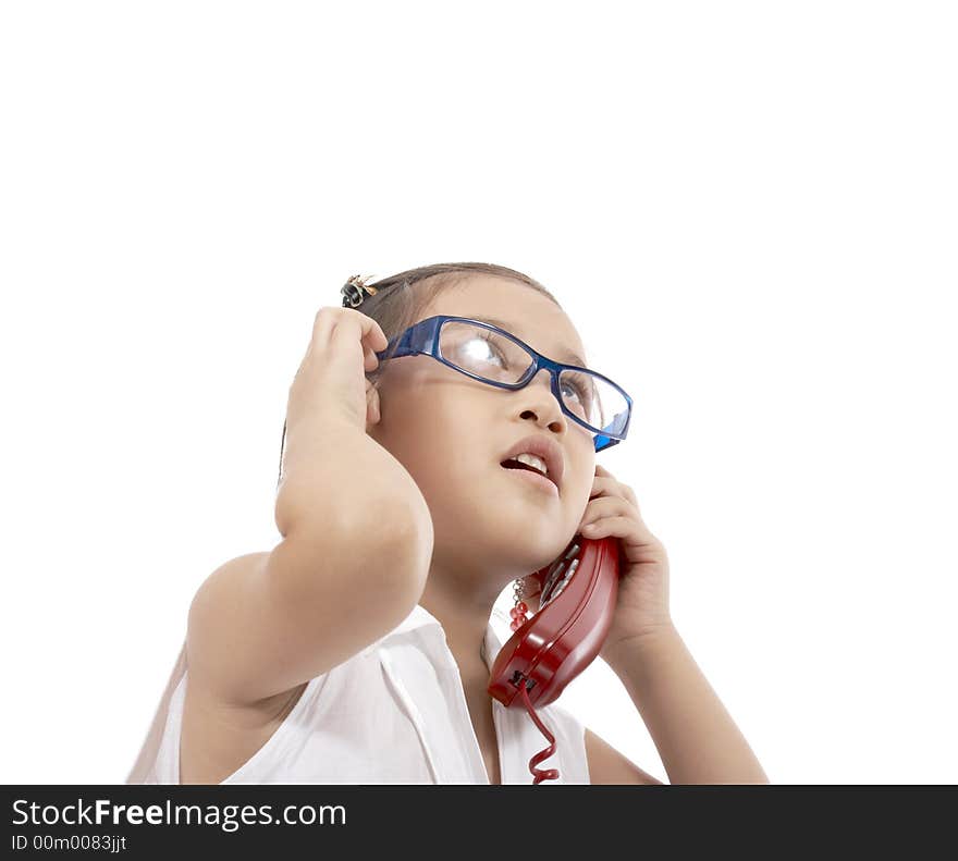 A young girl talking on the phone. A young girl talking on the phone