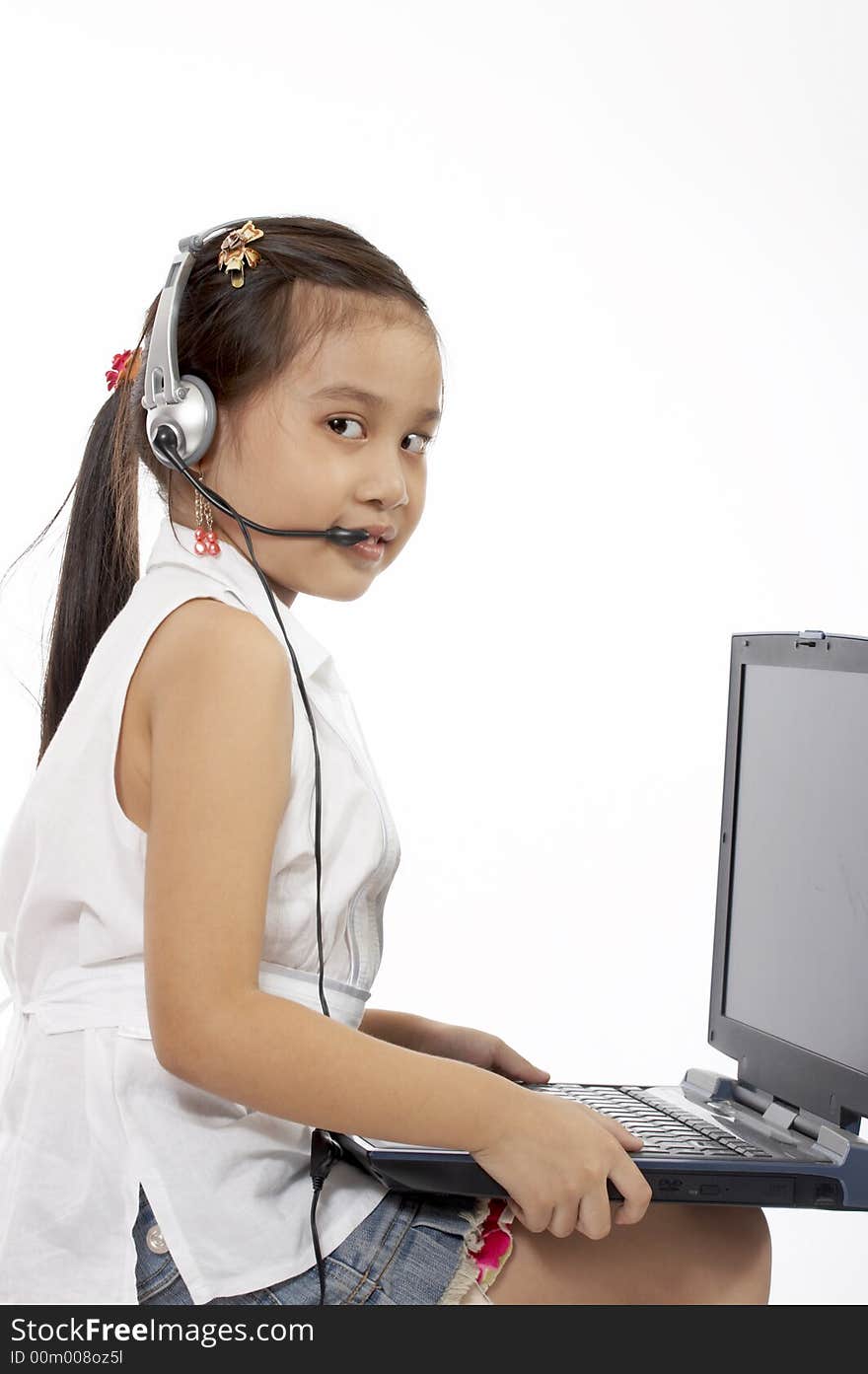 A young girl typing on a laptop. A young girl typing on a laptop