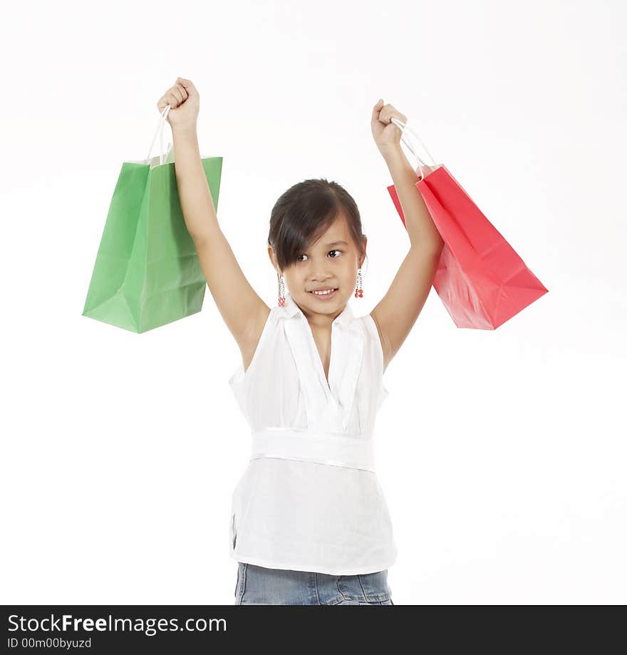 A young girl carrying a shopping bag