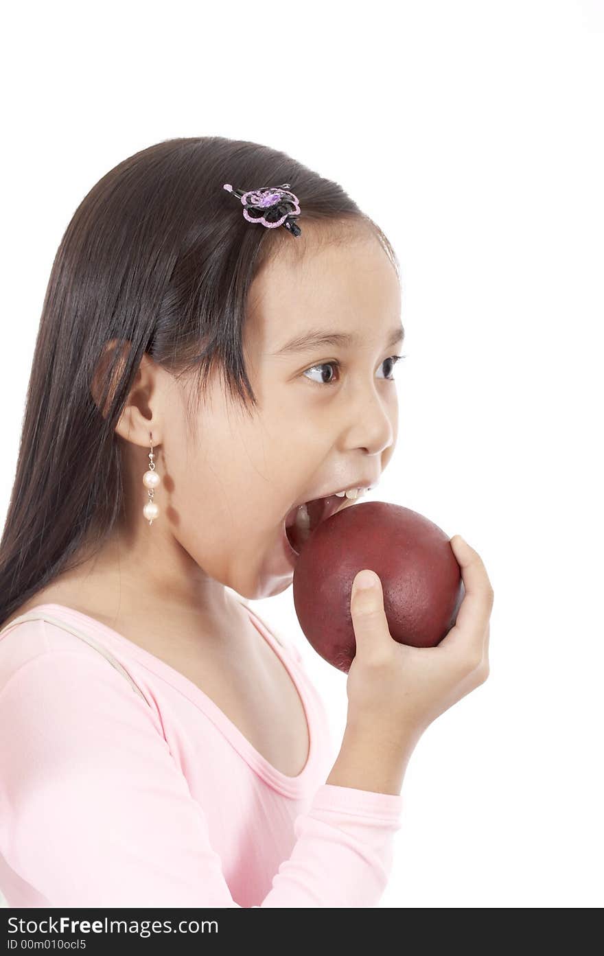 A girl biting an apple