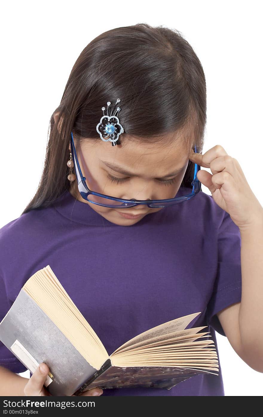 A young girl reading a book over a white background