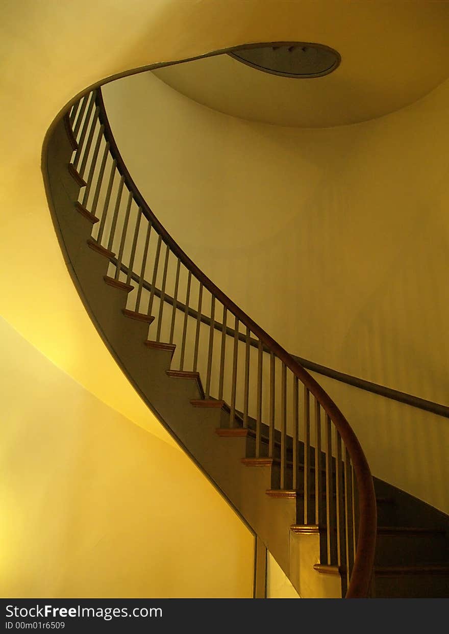 A curved staircase seems to flow upward. A curved staircase seems to flow upward.