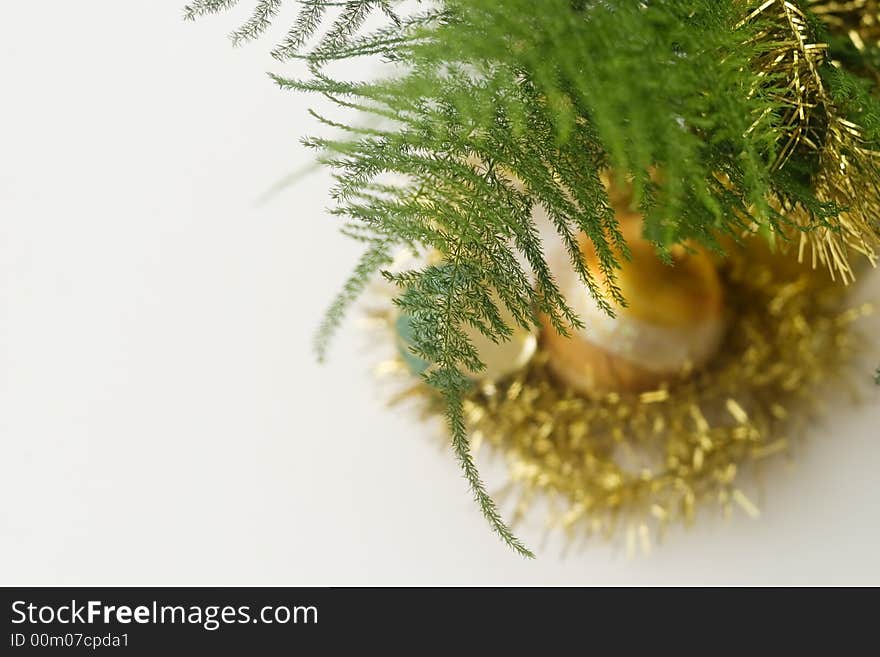 Green branch and a golden christmas glass decoration ball. Green branch and a golden christmas glass decoration ball.