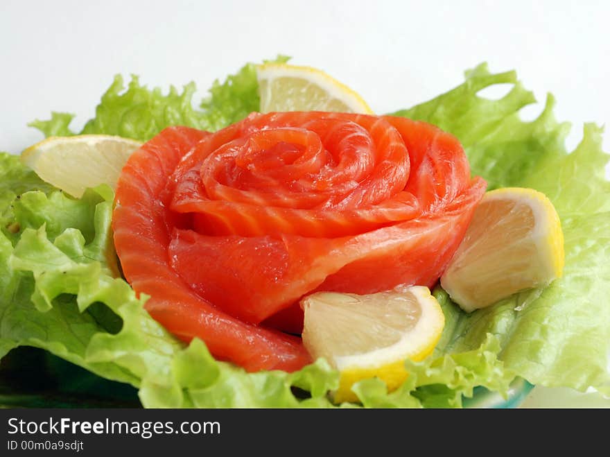 Delicious red fish and leafs close up